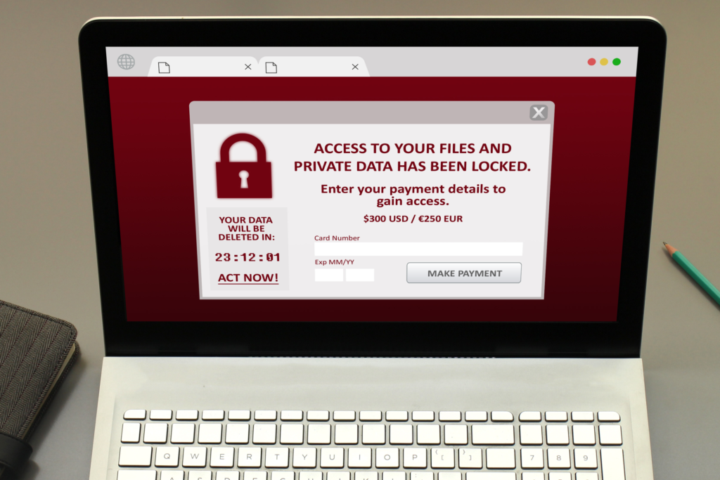 An open laptop showing a ransomware on a browser